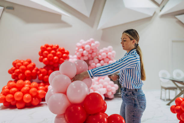 istock A female decorator creates the birthday decoration by making a balloon column 2156168310
