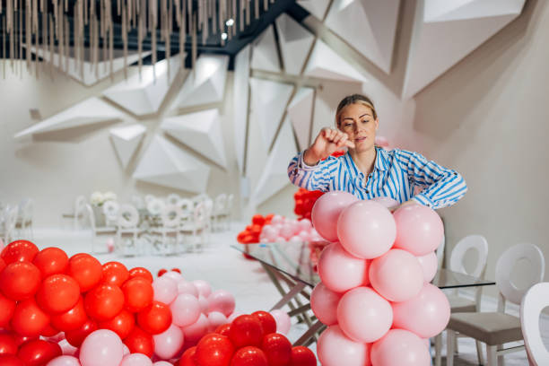 istock Woman party decorator arranging decorations for a birthday party 2156168367