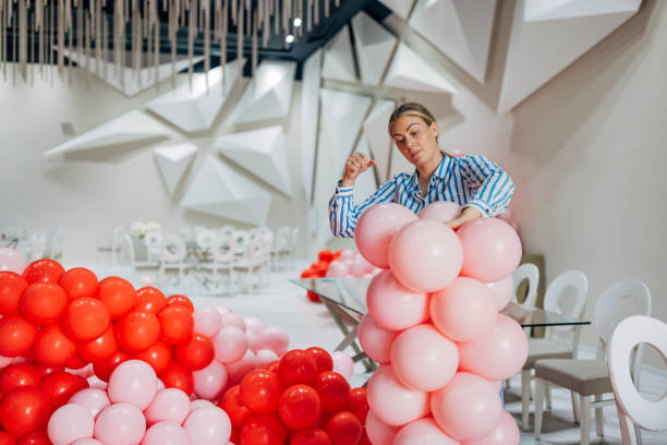 istock Female party decorator arranging decorations for a birthday party 2156168373