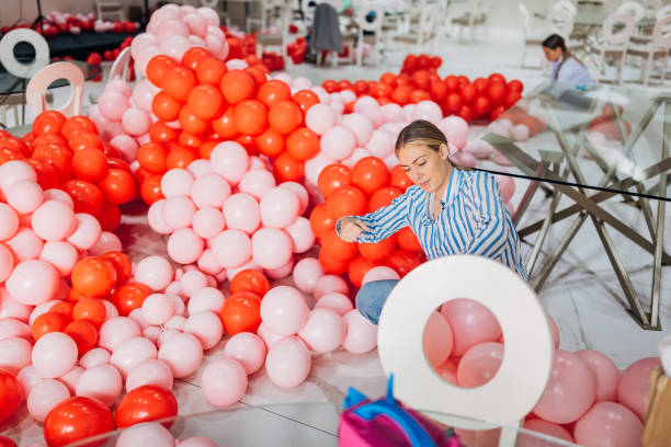 istock Two female decorators are making balloon decorations for a party 2156168981