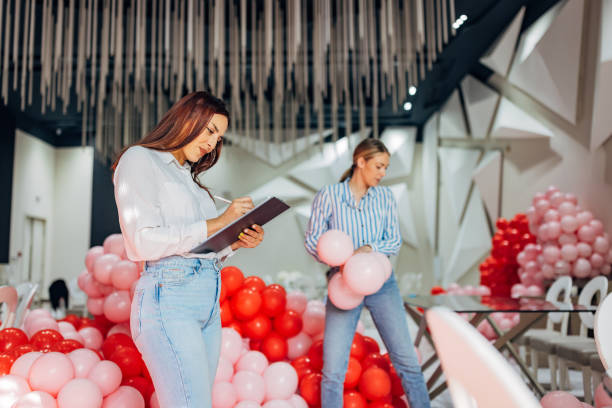 istock Two decorators and party organizers prepare decorations for a celebration in a restaurant 2156169218
