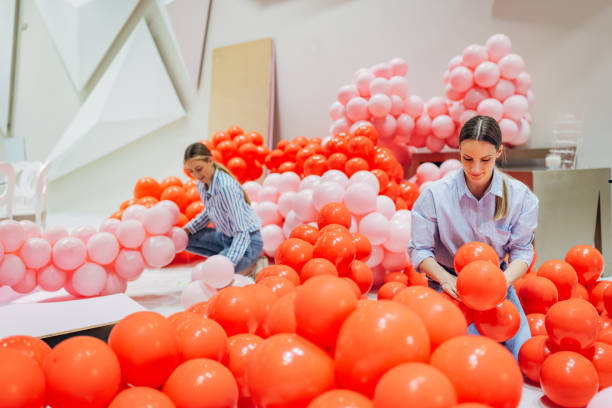 istock Two decorators and party organizers prepare decorations for a party in a restaurant 2156169252