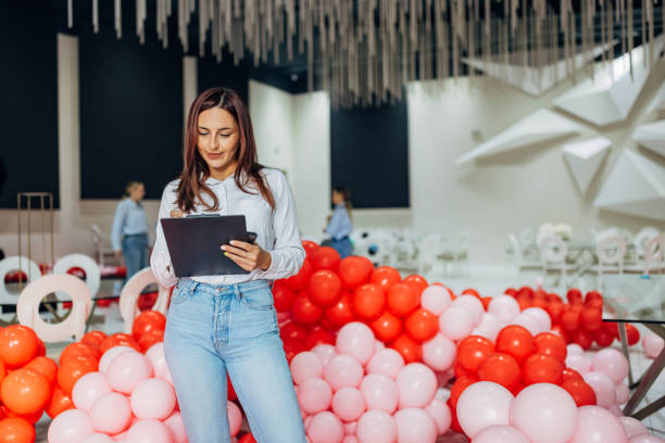 istock A party planner crosses tasks off her to-do list while decorating a restaurant for a party 2156169263