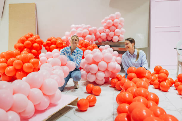 istock Two decorators are making a balloon arch for a party decoration in a restaurant 2156169359