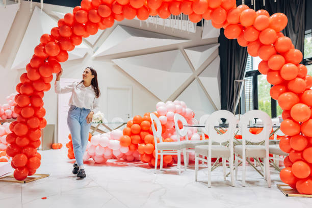 istock The decorator decorates the restaurant hall, making a decorative balloon arch 2156169779