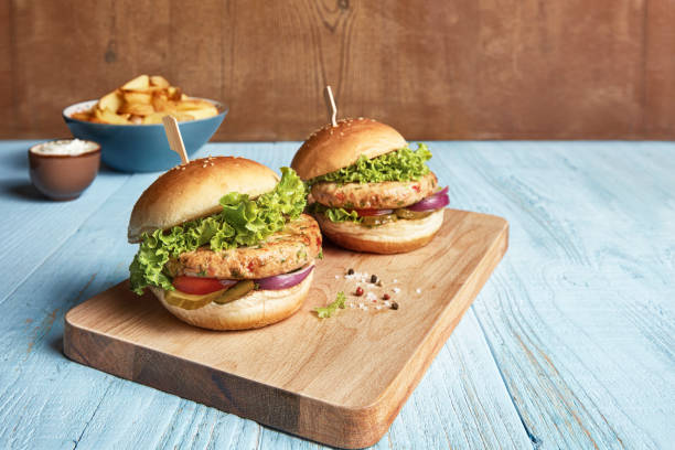 istock Two Burgers On Cutting Board 2156169835