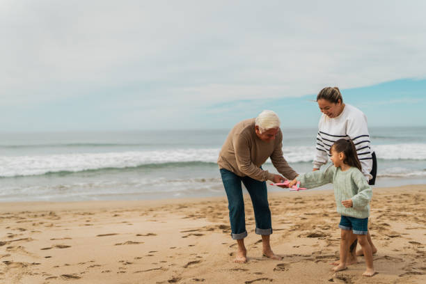 istock Family playing with the toy plane at beach 2156170037