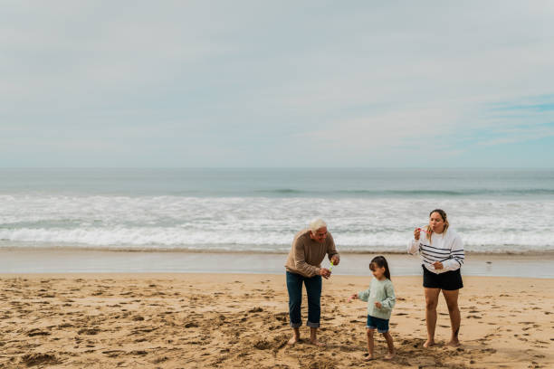 istock Family playing soap bubble at beach 2156170153
