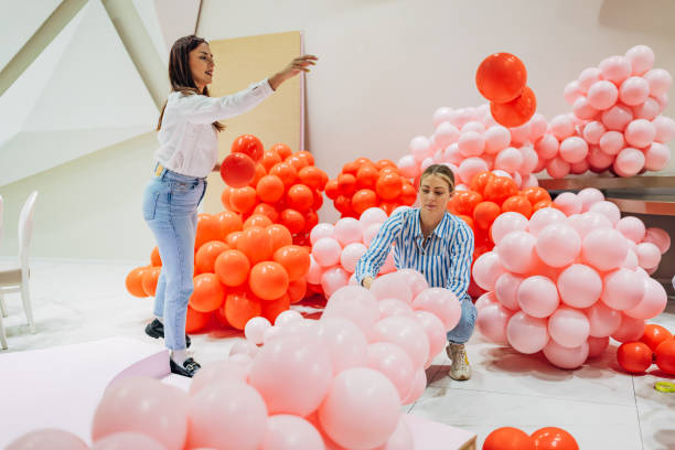 istock Two women decorators are making a balloon arch for a party decoration 2156170340