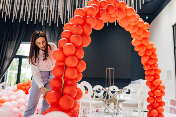 istock Focused decorator making a balloon arch for restaurant party decoration 2156170398