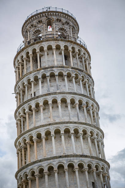 A breathtaking view of Italy's pisa famous Leaning Tower under a blue sky, highlighting its grandeur and beauty