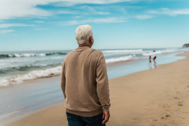 istock Senior man walking on the beach 2156170641