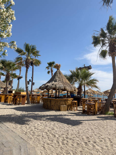 istock Sun loungers, umbrellas and tables on beach 2156171091