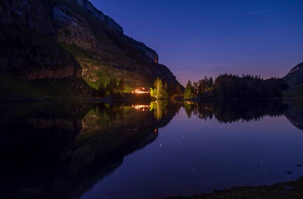 istock Reflecting alpine landscape in a lake at night 2156171382