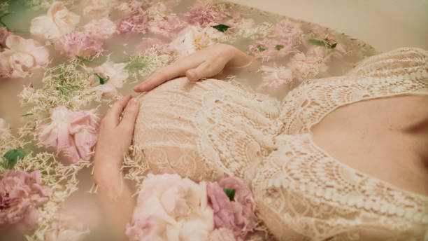 istock Bathing during pregnancy in pink flowers - Peonies. 2156171812