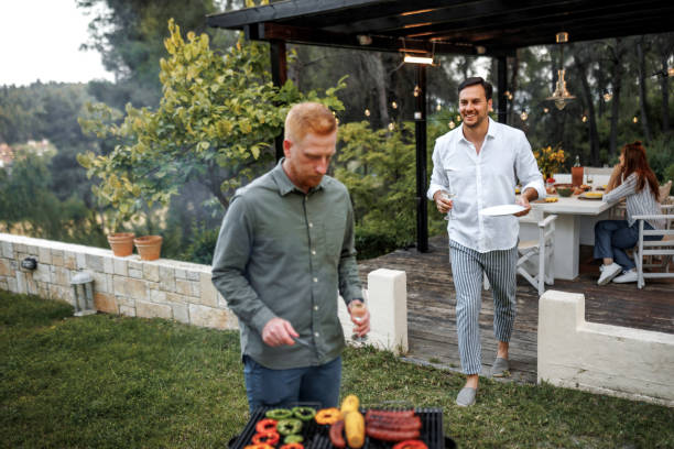 istock Friends having barbeque party at the backyard 2156172602