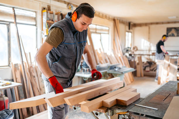 istock Young Male Carpenter Working With Wood In His Workshop 2156174661