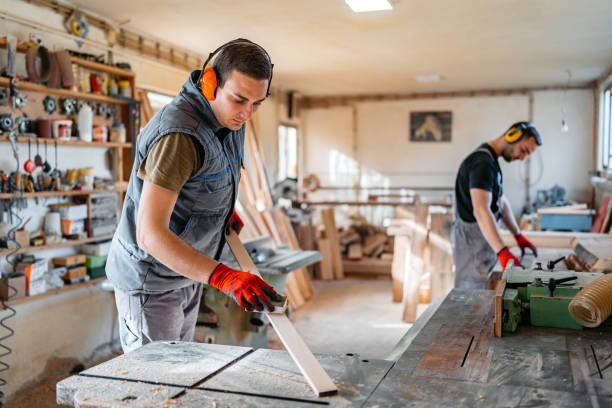 istock Young Male Carpenter Sanding The Wood In His Workshop 2156174665