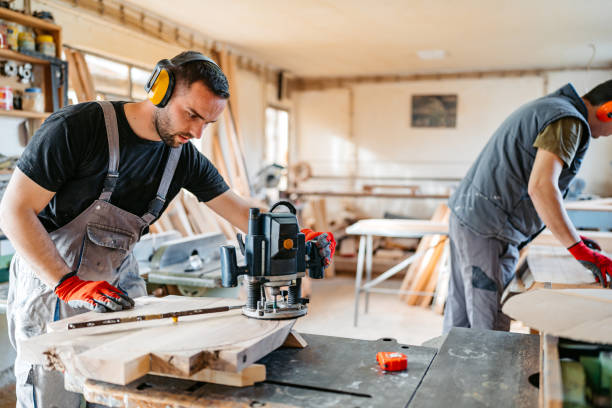 istock Young Male Carpenter Sanding The Wood In His Workshop 2156174676
