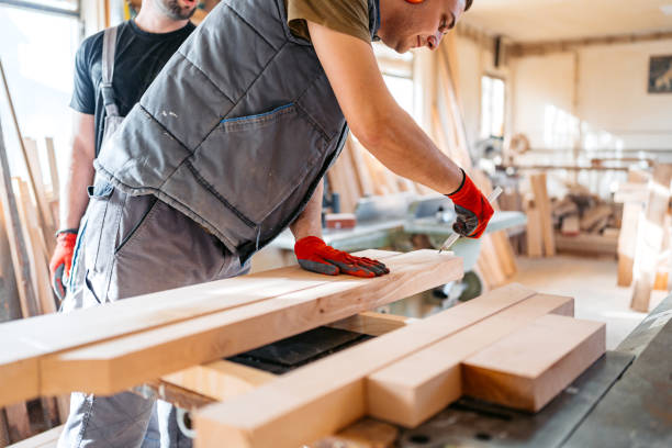 istock Young Male Carpenter Marking And Measuring Wood In His Workshop 2156174687