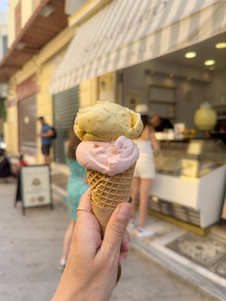 istock ice cream cone in the hand at street 2156174691