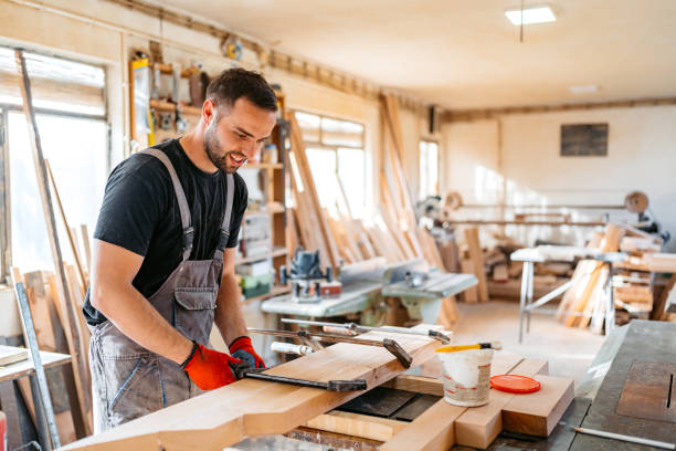 istock Young Male Carpenter Working With Wood In His Workshop 2156175054