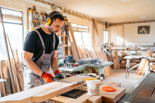 istock Young Male Carpenter Working With Wood In His Workshop 2156175235