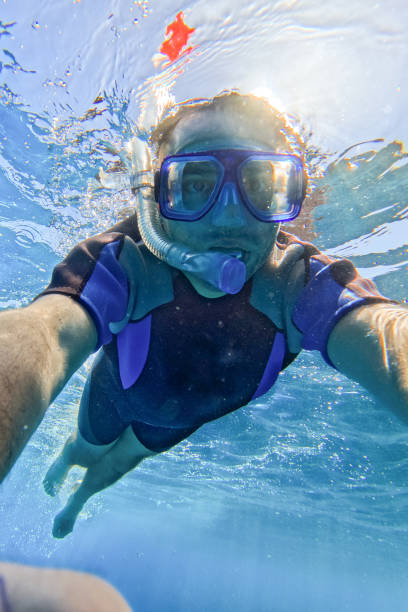 Young man  taking a selfie while snorkeling in the Red sea in Hurghada in Egypt.