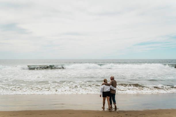 istock Father talking to daughter and walking on the beach 2156176846