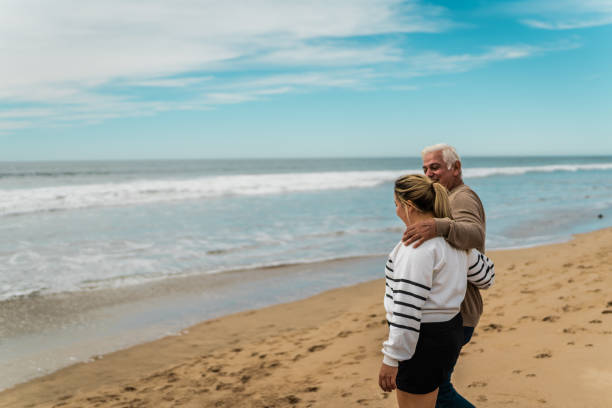 istock Father talking to daughter and walking on the beach 2156176848