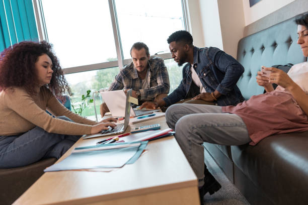 istock A group of students, huddled over textbooks and notes, diligently prepare for an upcoming exam. 2156177082