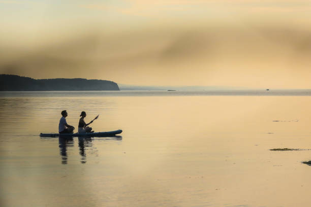 istock Couple Having A Pleasant Time Sailing The Sea At Sunset By SUP 2156178528