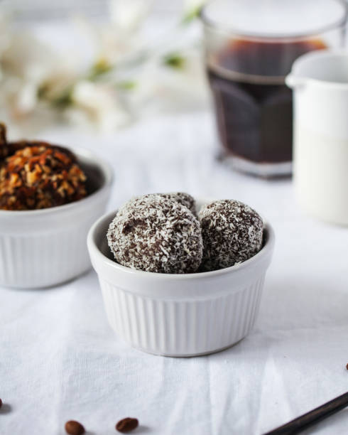 istock Craft chocolate candies with coconut flakes in ceramic bowl 2156178884