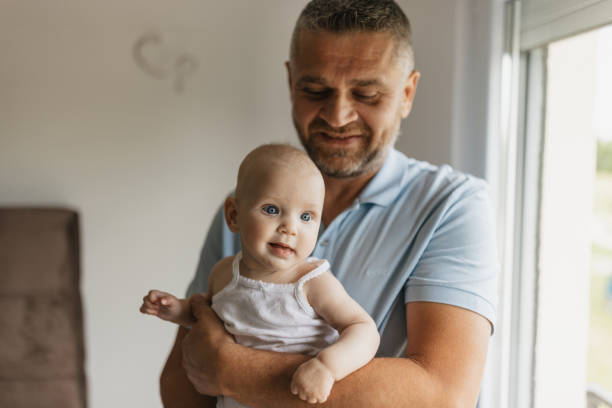 istock Father holding his baby with tender care 2156179151