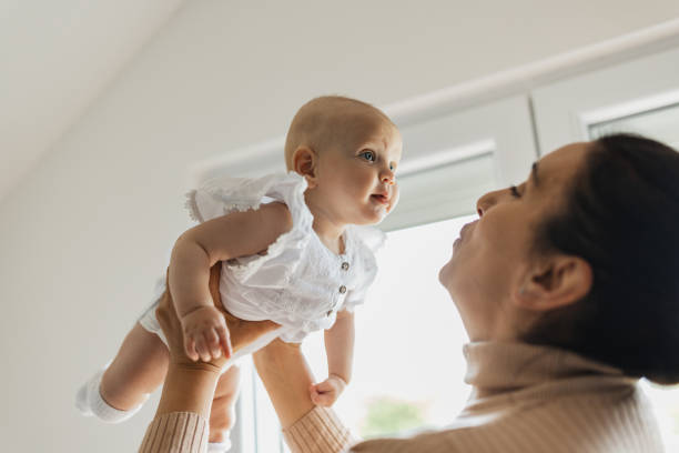 istock Baby raised by a woman's hands 2156179284