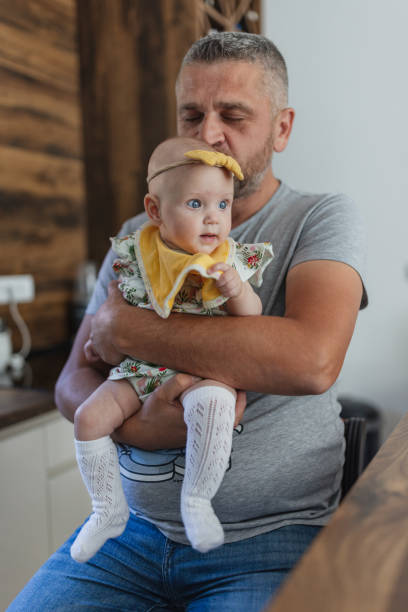 istock Father holding baby with a concerned look 2156179445