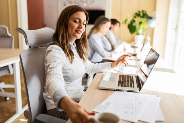 istock Young Businesswoman Completing Paperwork 2156181030
