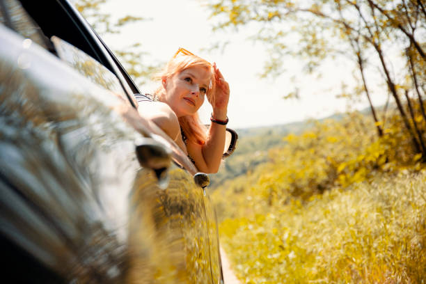 istock Woman enjoying car trip 2156182582