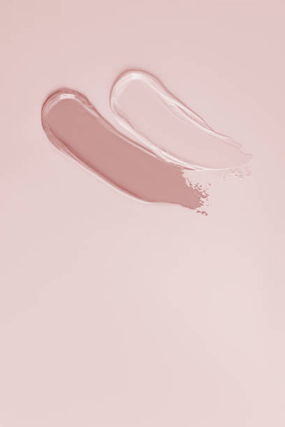 istock Two samples of cosmetic foundation in pink and light tones on a pastel background. Top Vertical view. A copy space. Mockup for cosmetics design. 2156182611