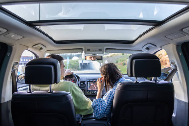 istock Rear back view from passenger seat of man and lady sitting inside car. 2156183066
