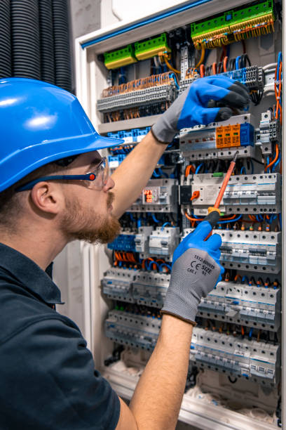 istock Male electrician working in a switchboard with fuses. 2156183389