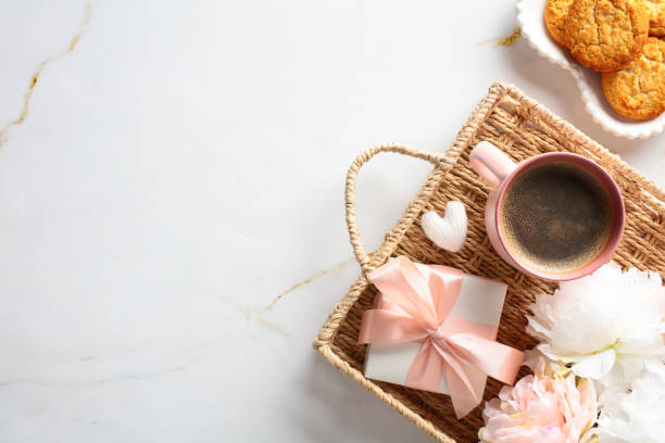 istock A serene coffee break setup with a cup, cookies, a gift, and flowers on a marble backdrop, perfect for lifestyle content. 2156184636