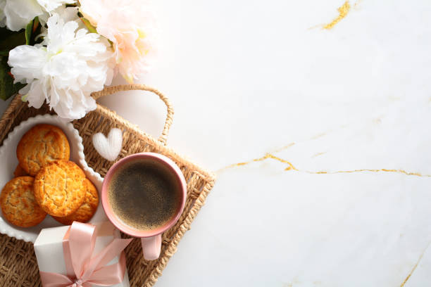 istock Breakfast setting with coffee, cookies, and fresh flowers on a marble surface. Cozy morning atmosphere. 2156184668