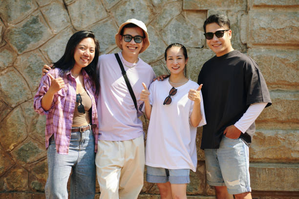 Friends posing and smiling for a group photo, creating a happy memory