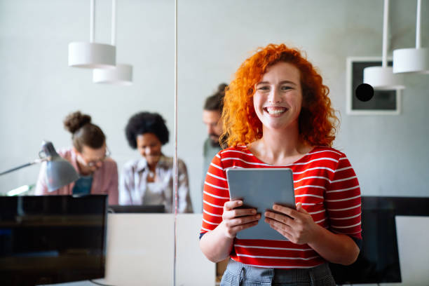 istock Group of business people and software developers working as a team in modern startup office 2156188361