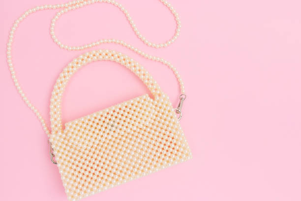 istock Handmade bag made from pearl imitation beads on a pink background. 2156190649
