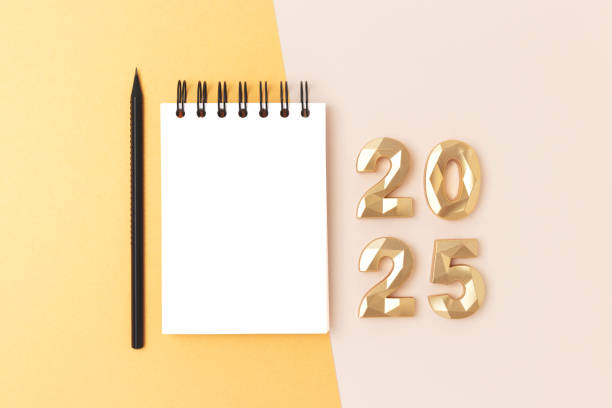 istock Blank notepad mockup, pencil and golden 2025 numbers on a beige background. 2156190749