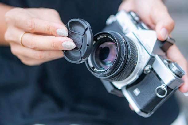 istock Removing lens cap from vintage film camera 2156193587