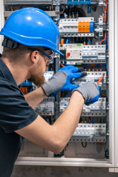 istock A male electrician works in a switchboard with an electrical connecting cable. 2156195014