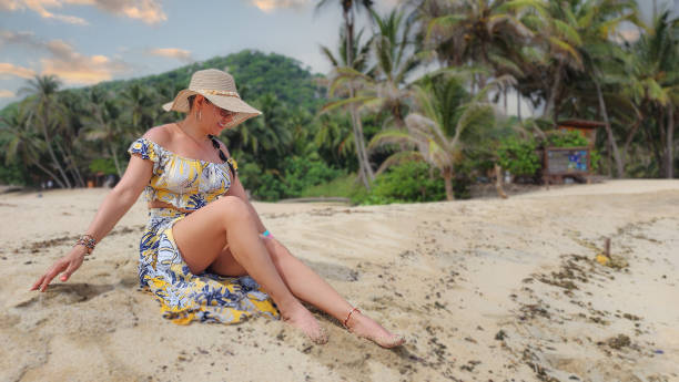 istock Woman sitting on a paradise beach 2156196563